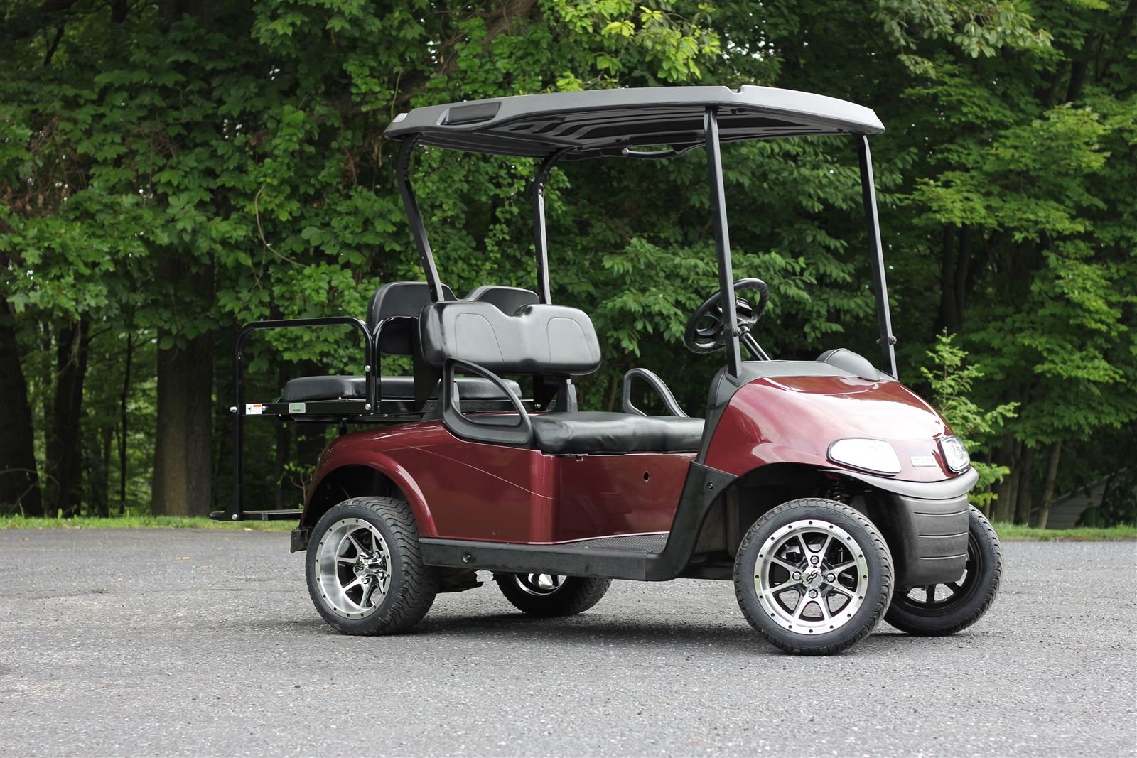 Maroon EZGO RXV custom golf cart with machined black wheels